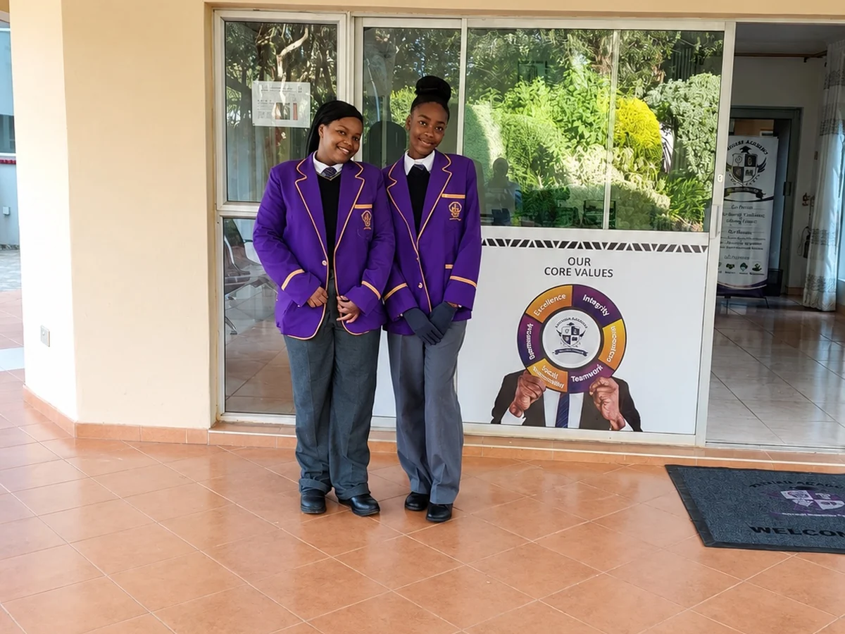 Two Privian Academy pupils in the entrance hall of the school