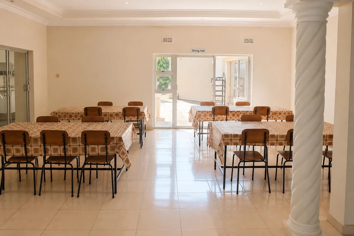 The dining hall at Privian Academy, laid tables running the length of the room